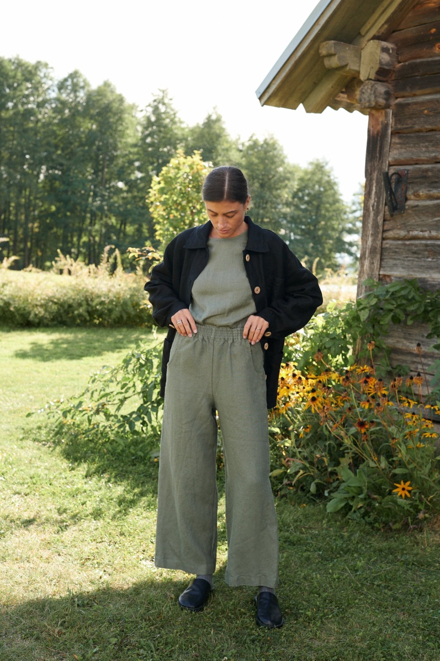 Woman wearing muted green wide leg linen trousers