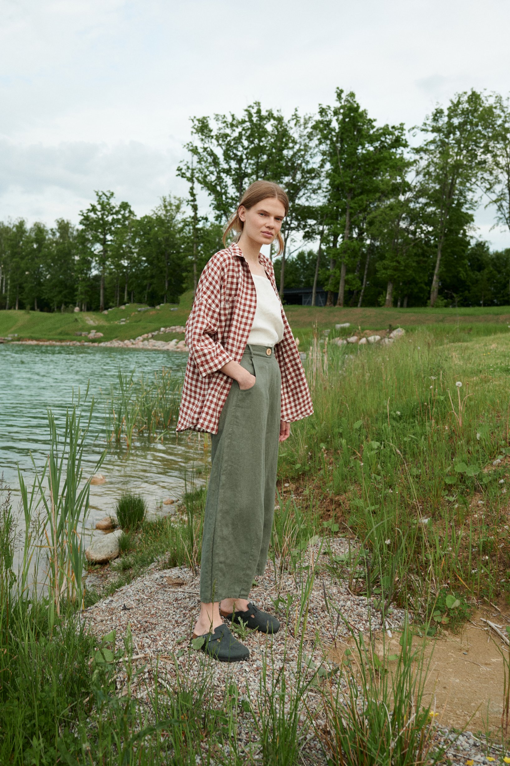 A woman in green linen high waisted trousers