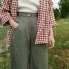 Pine green linen trousers on a model