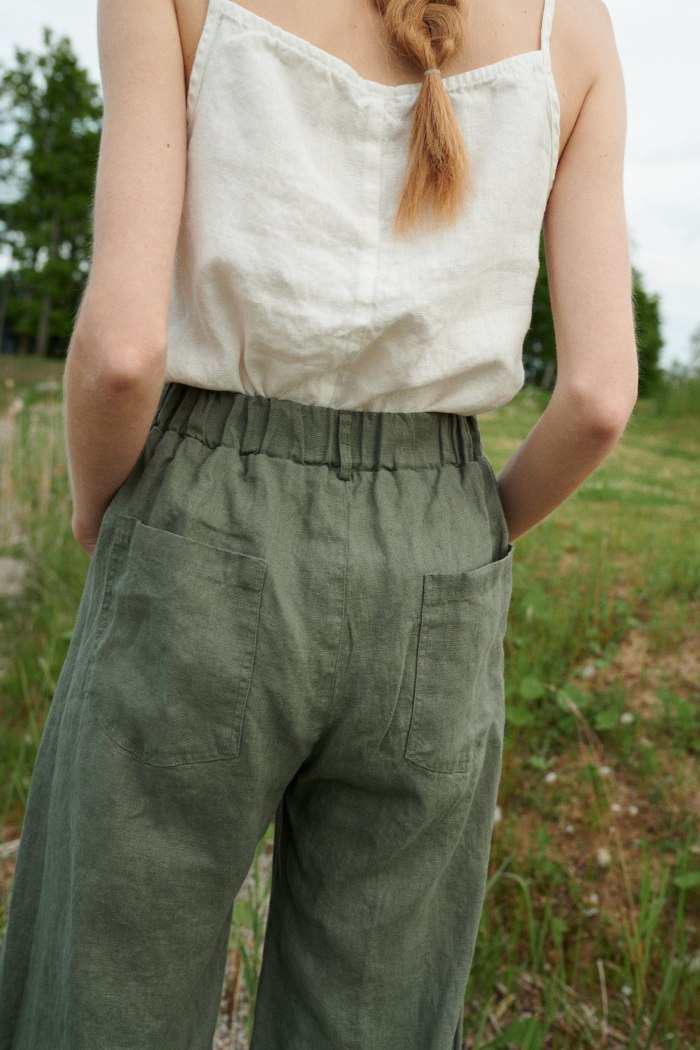 The back of pine green linen trousers