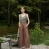 A woman in brown barrel leg heavy linen pants