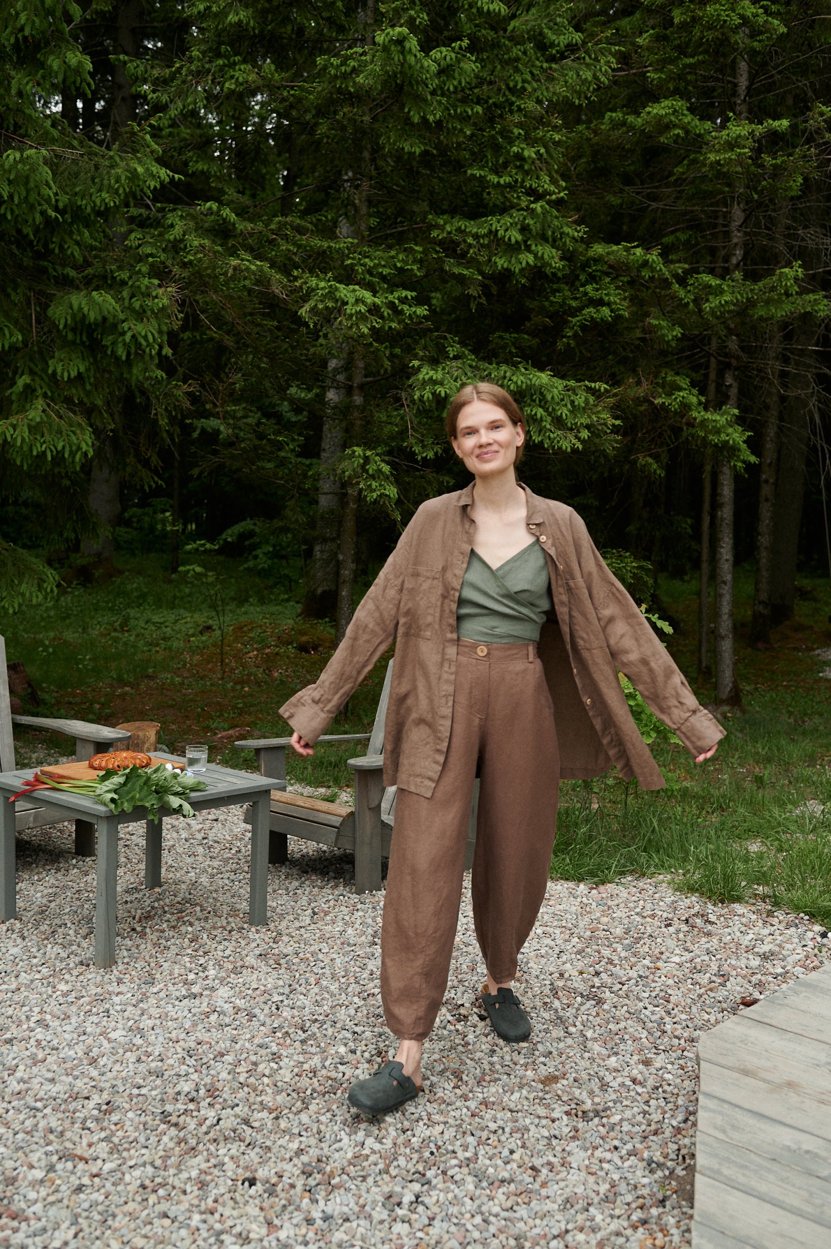 A model in cacao brown set of heavy linen trousers and a shirt