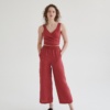 Woman wearing high-waisted linen pants with pockets paired with a matching linen wrap top