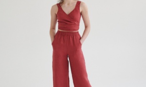 Woman wearing high-waisted linen pants with pockets paired with a matching linen wrap top