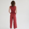 Back of a woman in wide-leg linen trousers and a matching sleeveless wrap linen top