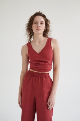 Model in a wrap sleeveless linen top and high-waisted linen trousers outfit
