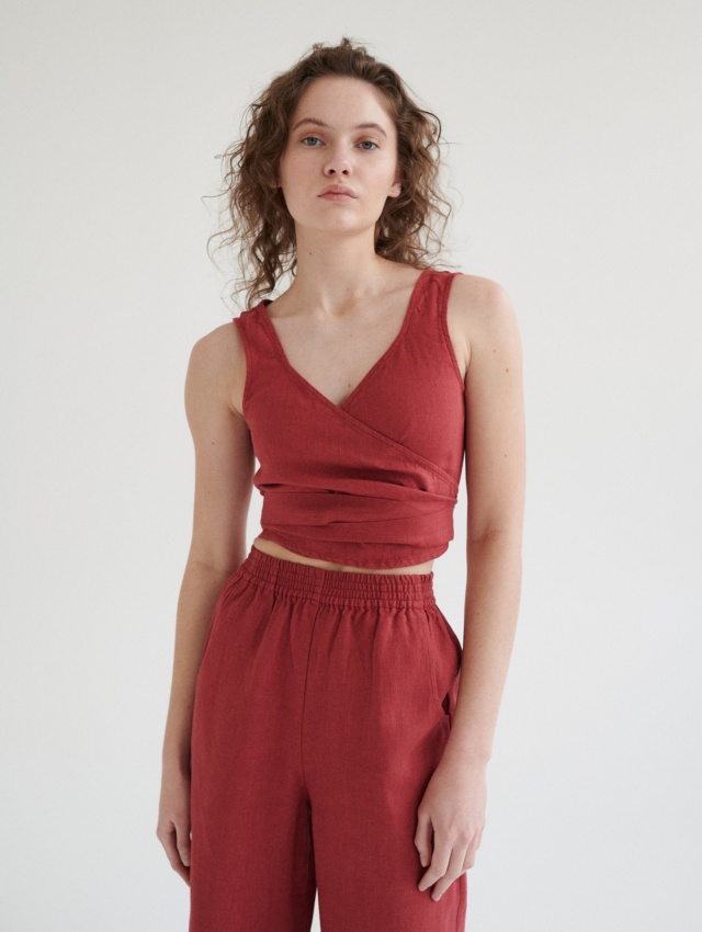 Model in a wrap sleeveless linen top and high-waisted linen trousers outfit