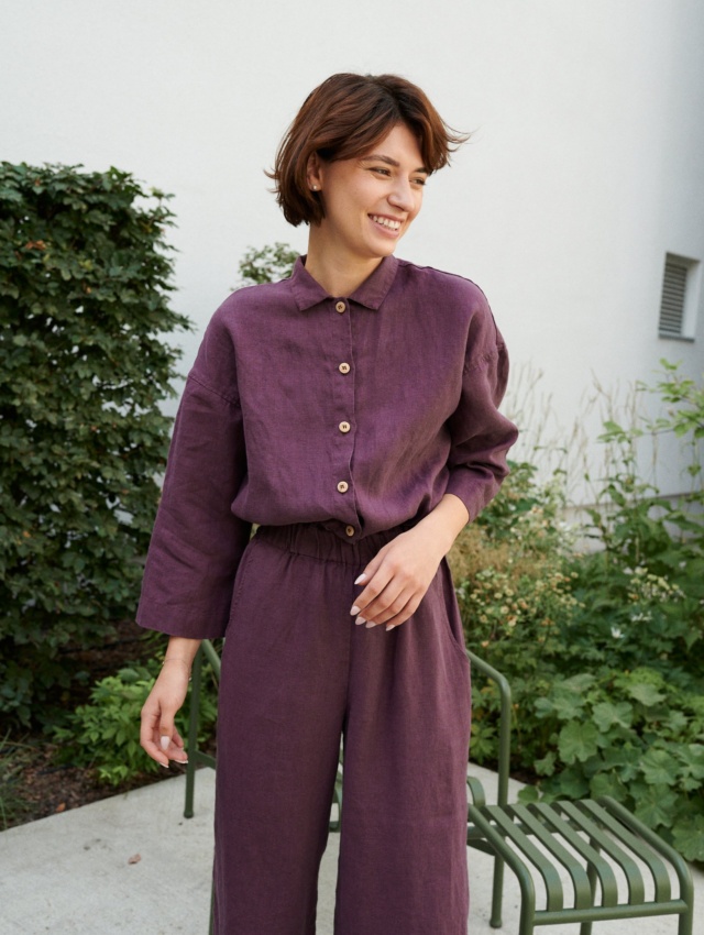 An eggplant violet button-down linen jumpsuit with an elasticated waistband