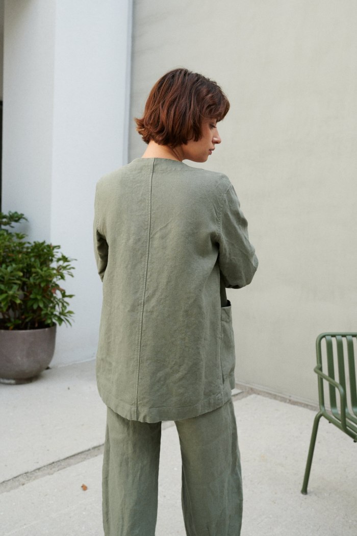 Back of a relaxed fit green heavy linen jacket