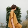 Model in and oversized camel linen top and matching linen pants outfit