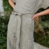 A grey stripes linen jumpsuit with a wrap construction and a matching belt