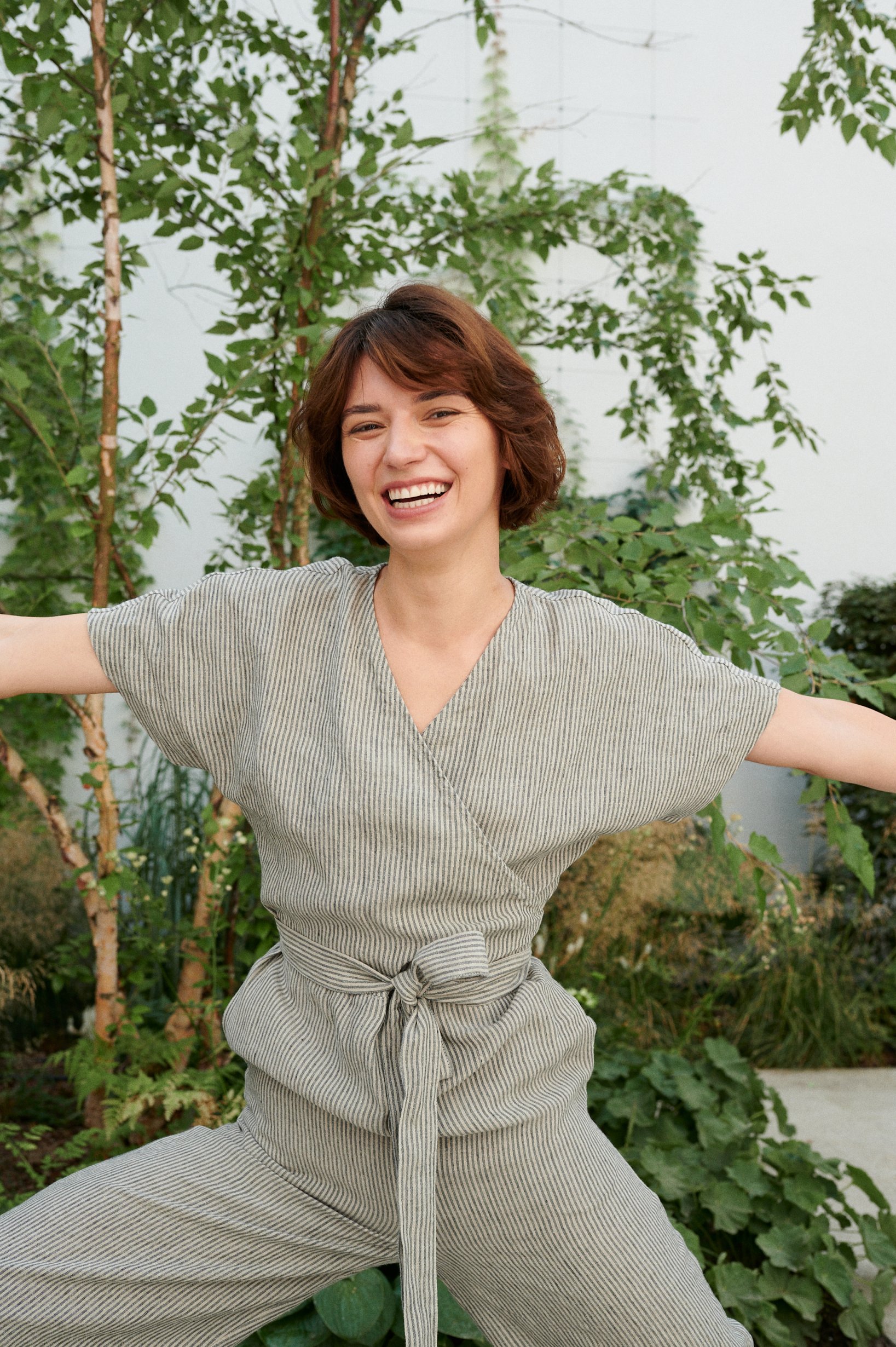 Model in a linen jumpsuit with a V-neckline and short sleeves