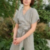 A relaxed fit grey linen jumpsuit with a deep V-neckline