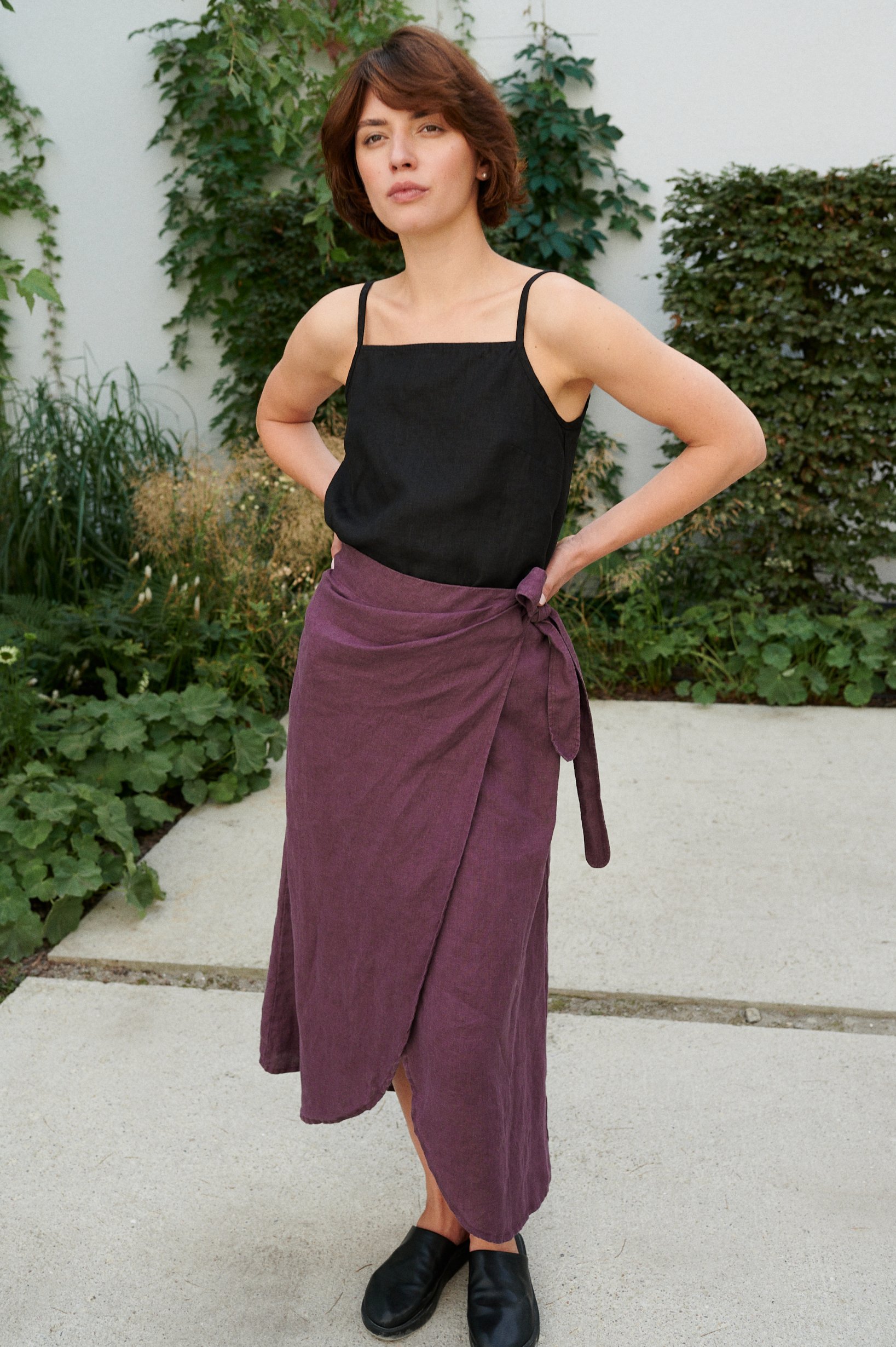 Woman in a long wrap linen skirt and a spaghetti strap linen top