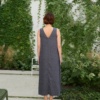 Model in a long linen dress with a V-neckline in the back