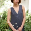 A sleeveless linen dress with a V-neckline in the front