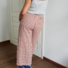 The back of high waisted linen trousers in terracotta gingham