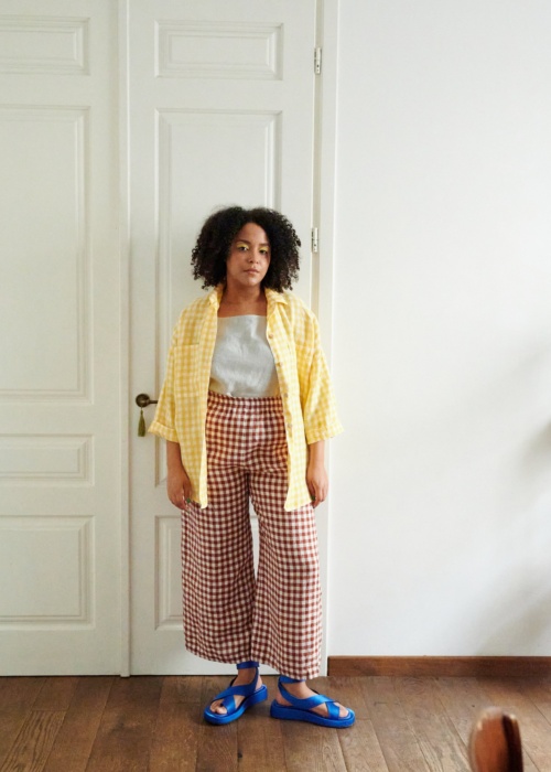 A model in brown gingham wide leg linen trousers