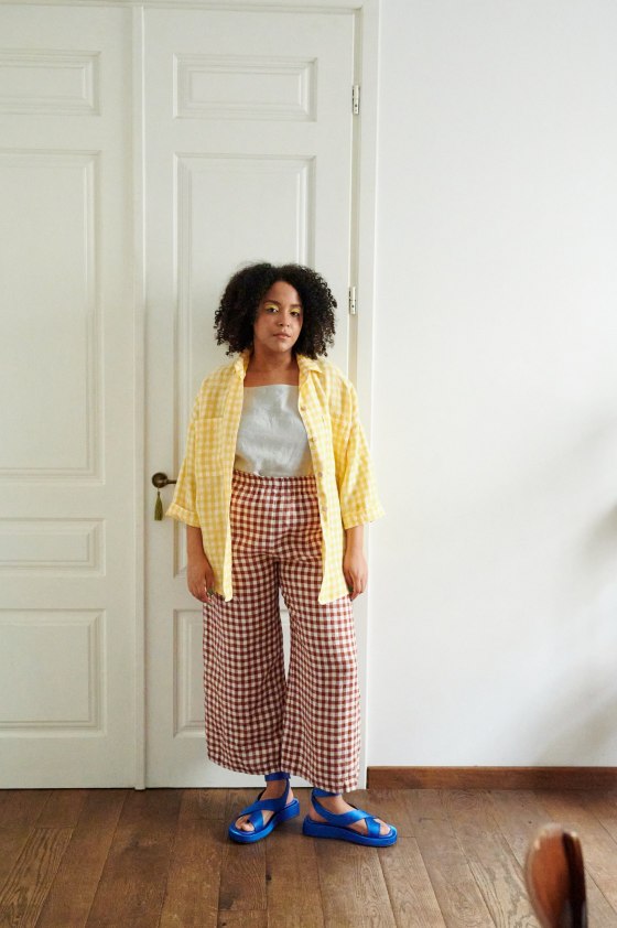 A model in brown gingham wide leg linen trousers
