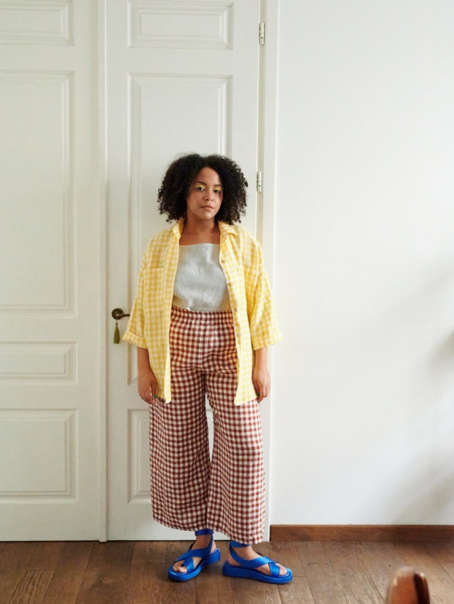 A model in brown gingham wide leg linen trousers