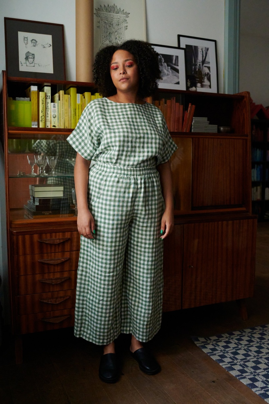 A woman wearing high elasticated waist linen trousers in green gingham