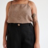 Black high-waisted linen trousers with a decorative wooden button