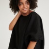 Model wearing black linen tunic
