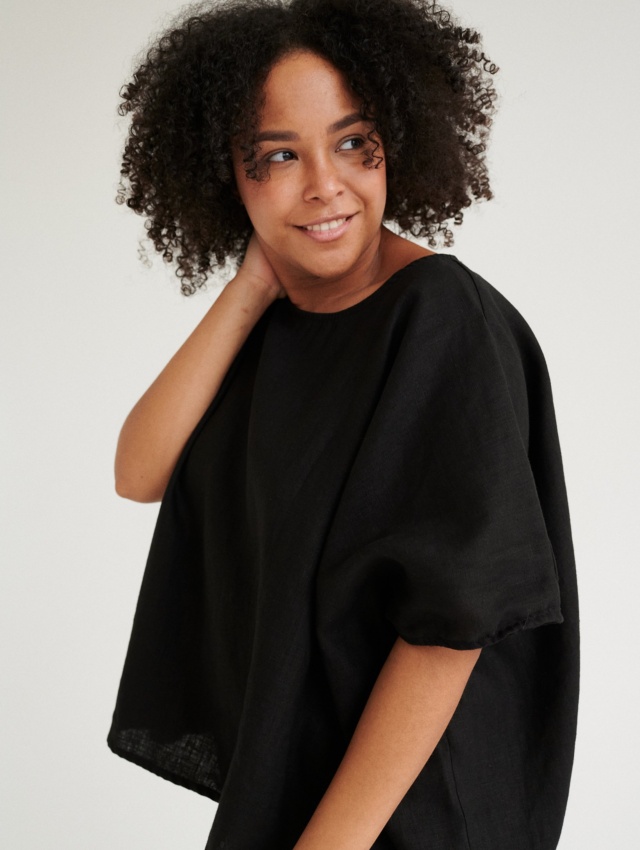 Model wearing black linen tunic