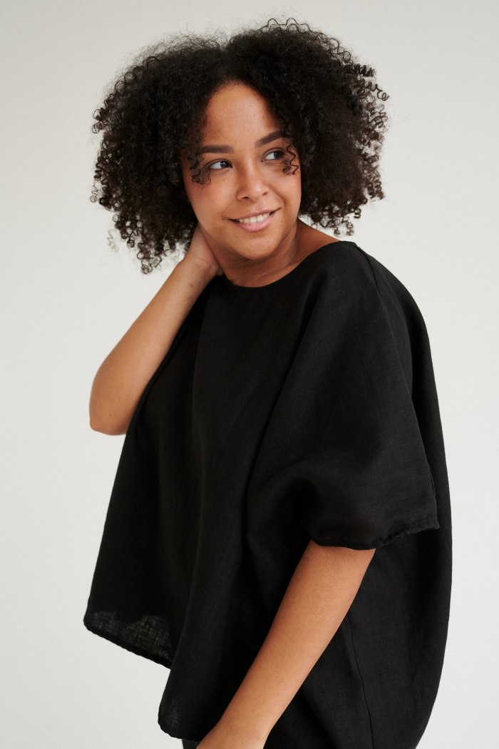 Model wearing black linen tunic