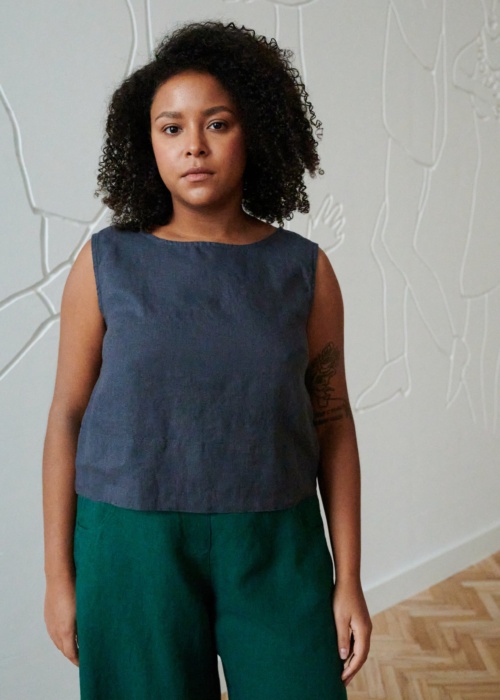Model in a blue cropped and sleeveless summer linen top