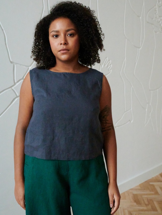 Model in a blue cropped and sleeveless summer linen top