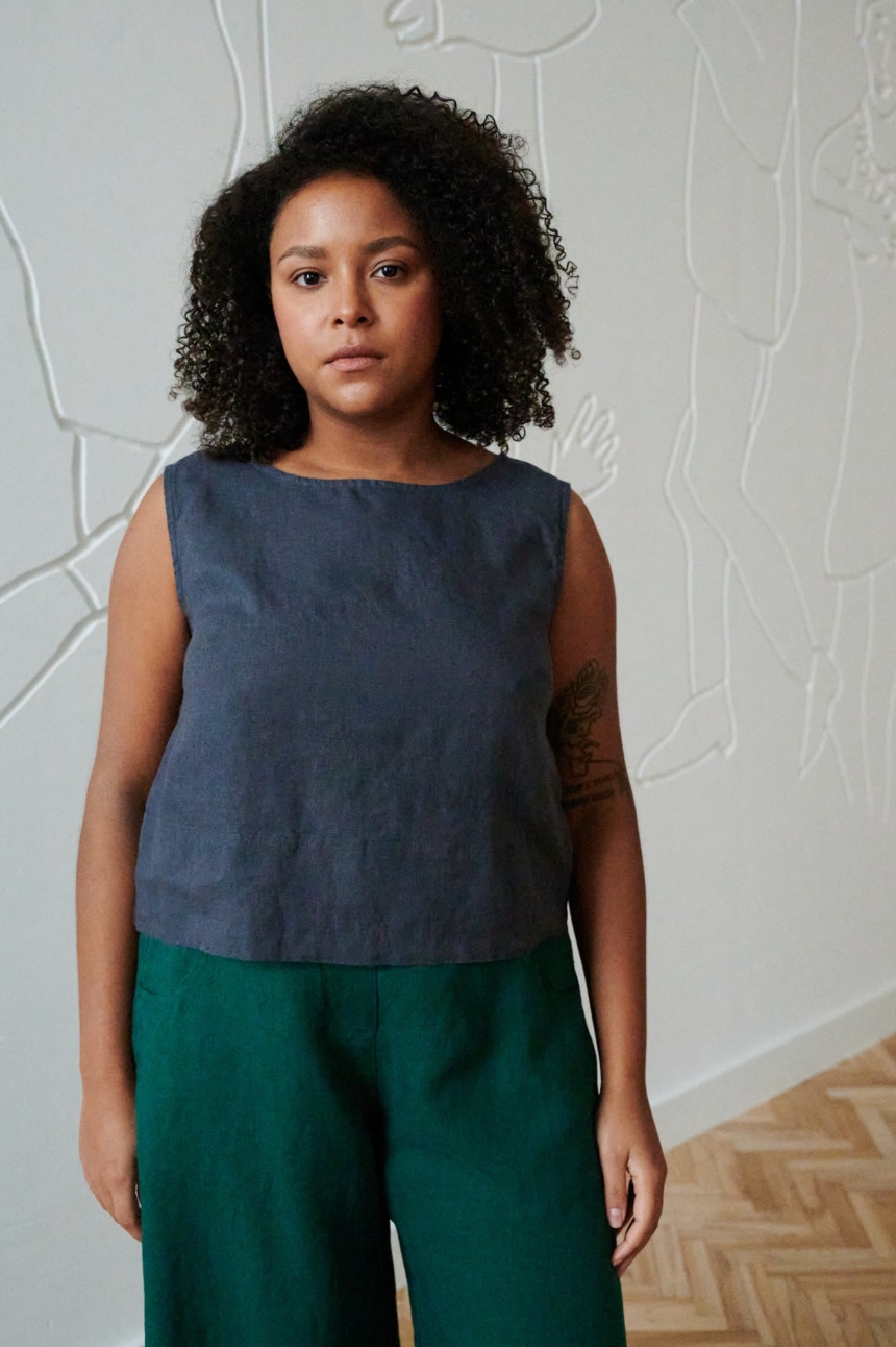 Model in a blue cropped and sleeveless summer linen top