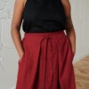 A burgundy red flowy linen skirt with pockets
