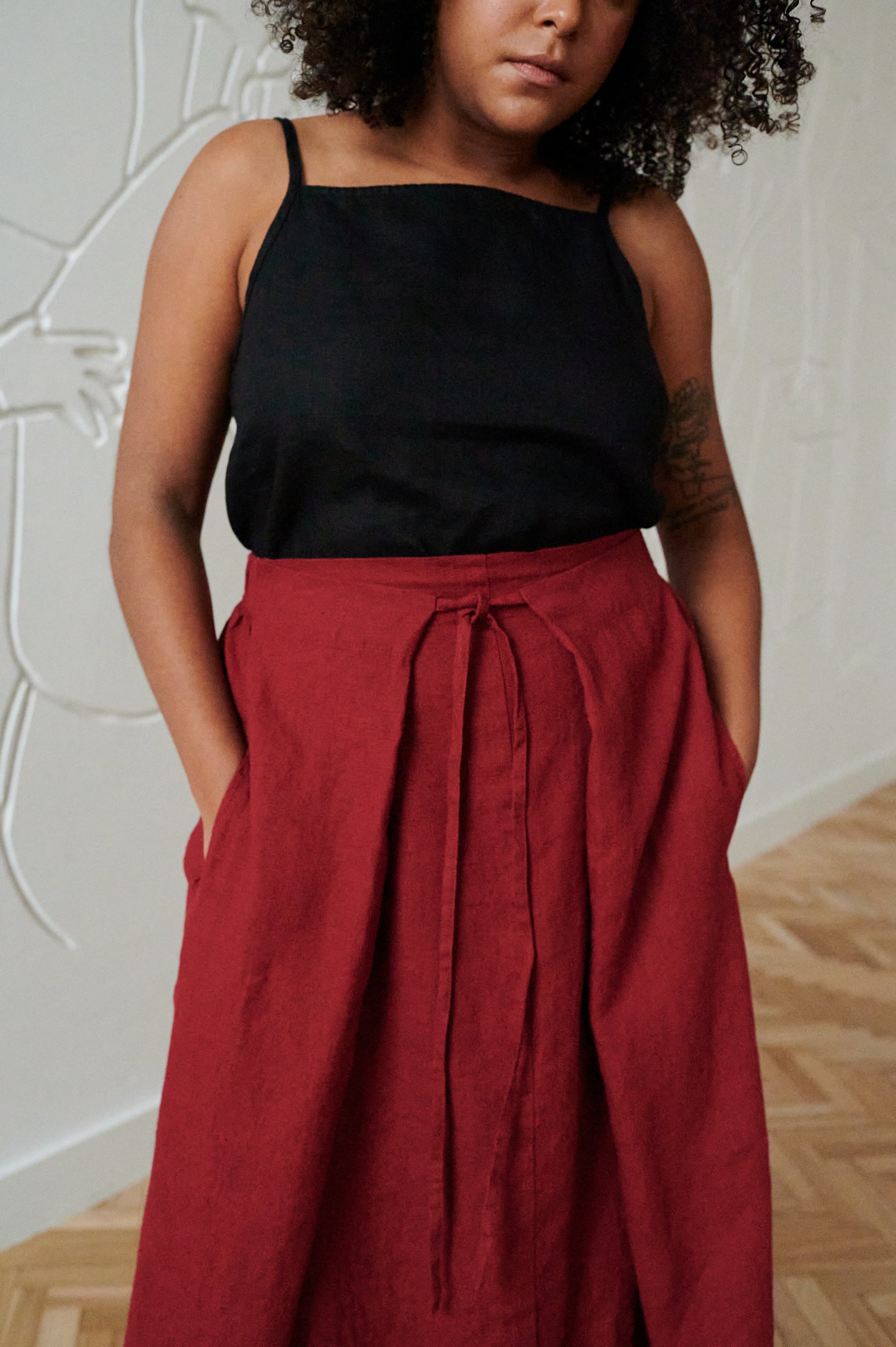 A burgundy red flowy linen skirt with pockets