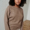 Model wearing a straight cut long sleeve linen blouse in cacao color