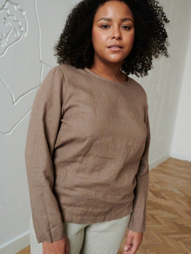 Model wearing a straight cut long sleeve linen blouse in cacao color