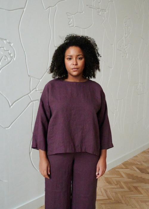 A woman in violet 3/4 sleeve tunic