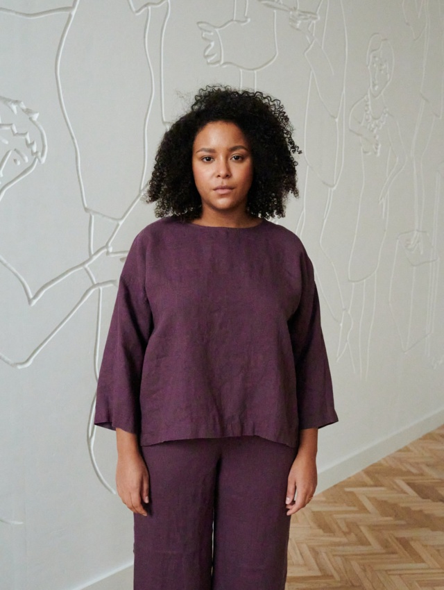 A woman in violet 3/4 sleeve tunic