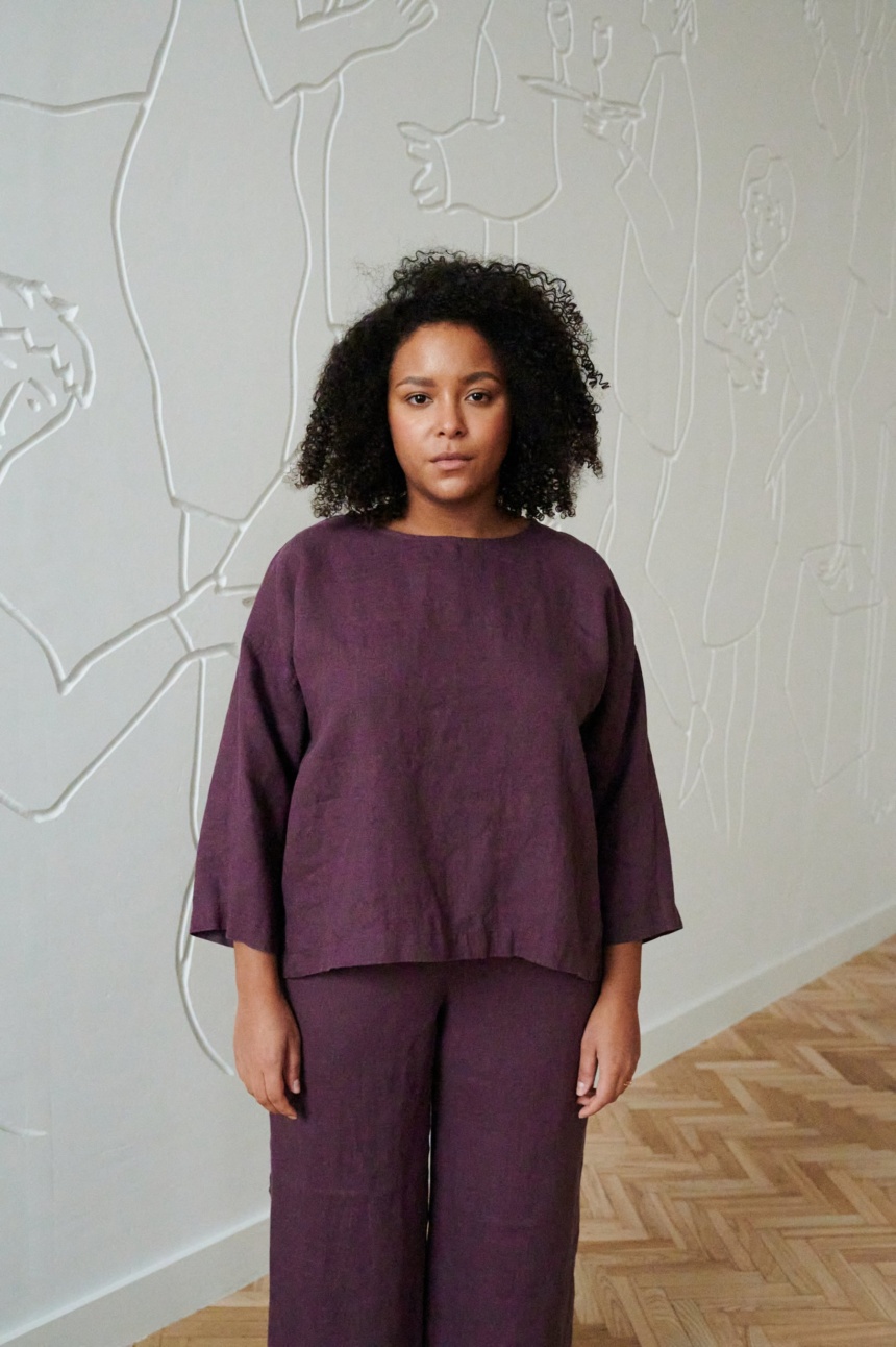 A woman in violet 3/4 sleeve tunic