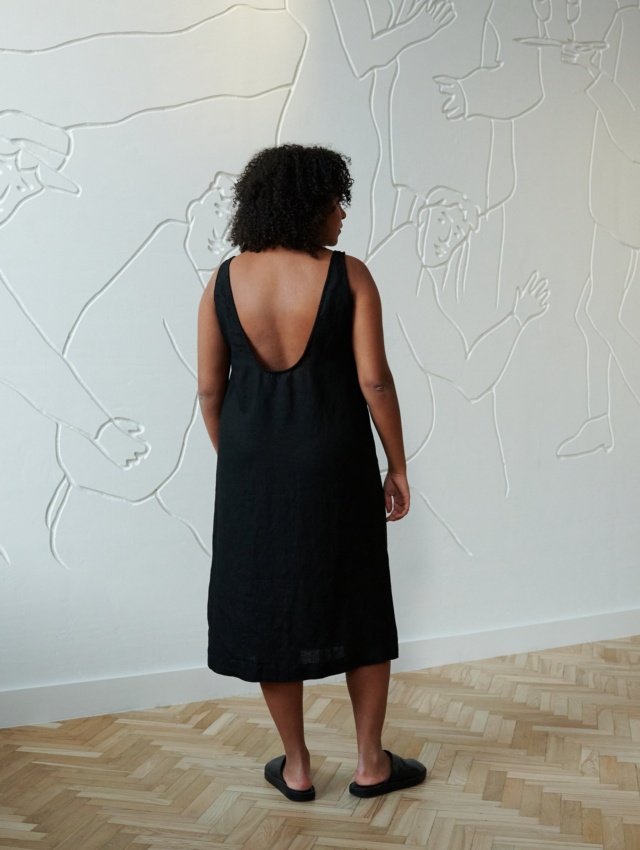 A relaxed fit black linen dress with a deep open back