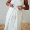 A long flowy linen skirt with two front pleats and a thin belt