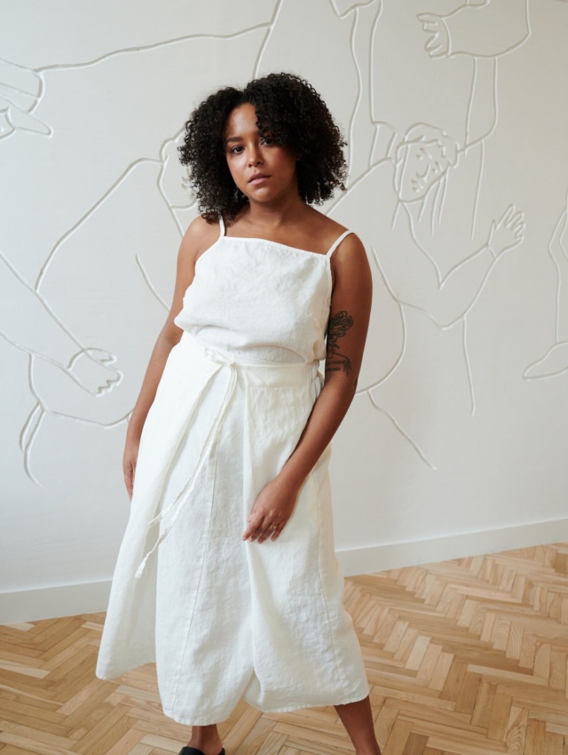 Model in a white long linen skirt with a matching sleeveless linen top