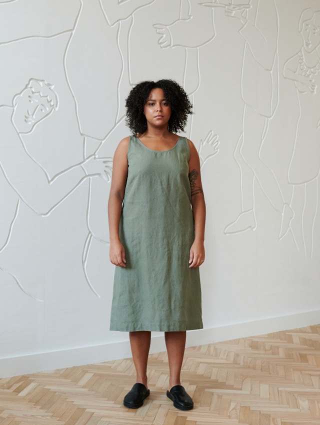 Model in a green midi sleeveless linen dress with a round neckline