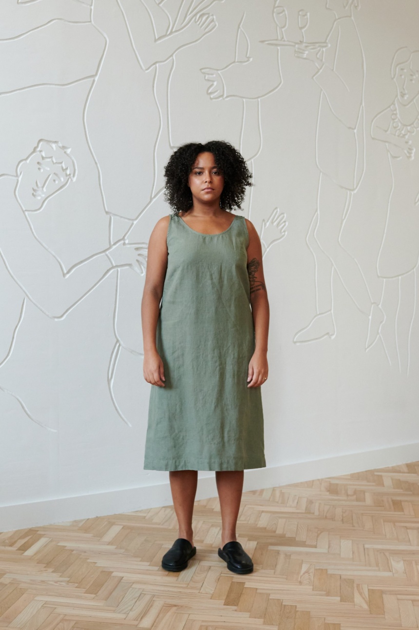 Model in a green midi sleeveless linen dress with a round neckline