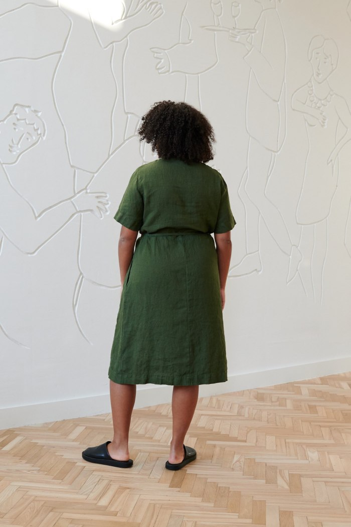 The back of midi linen green dress with a tie belt