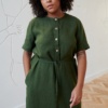 A woman in green linen midi dress with front buttons and a thin belt