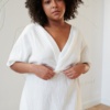 White linen dress with a twist in the front and short sleeves