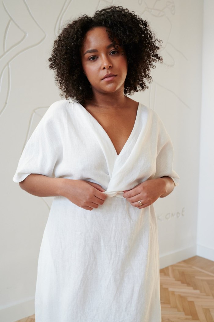 White linen dress with a twist in the front and short sleeves