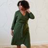 Model in a green linen wrap dress with long sleeves