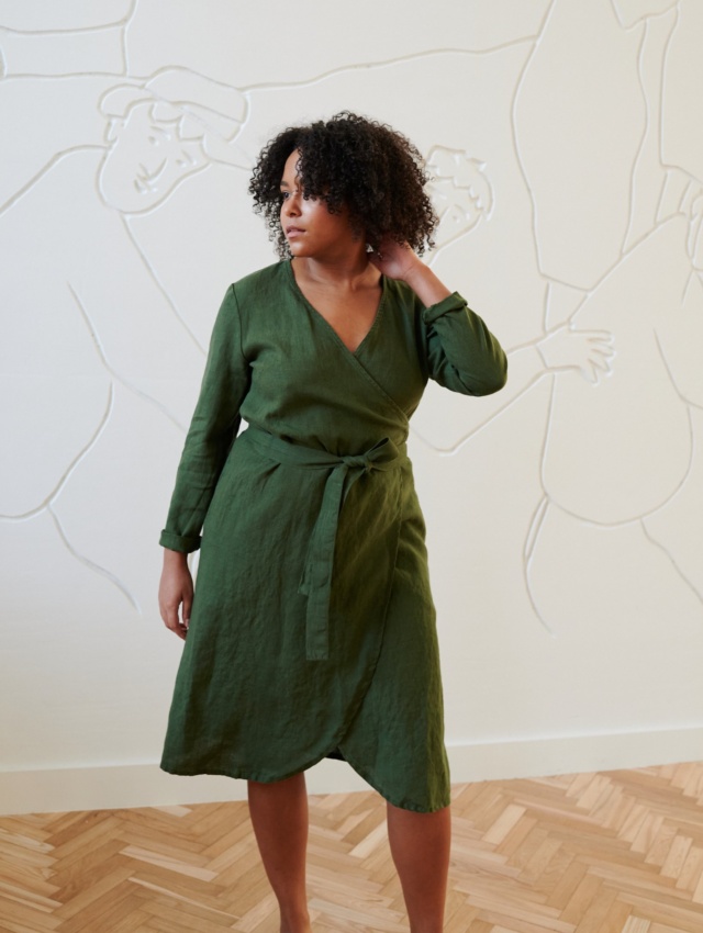 Model in a green linen wrap dress with long sleeves